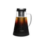 Glass carafe with black base and lid filled with iced coffee, brand 'Ovalware' visible.